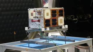 Ilustración del microsatélite argentino Atenea en el espacio, con la Tierra de fondo.
